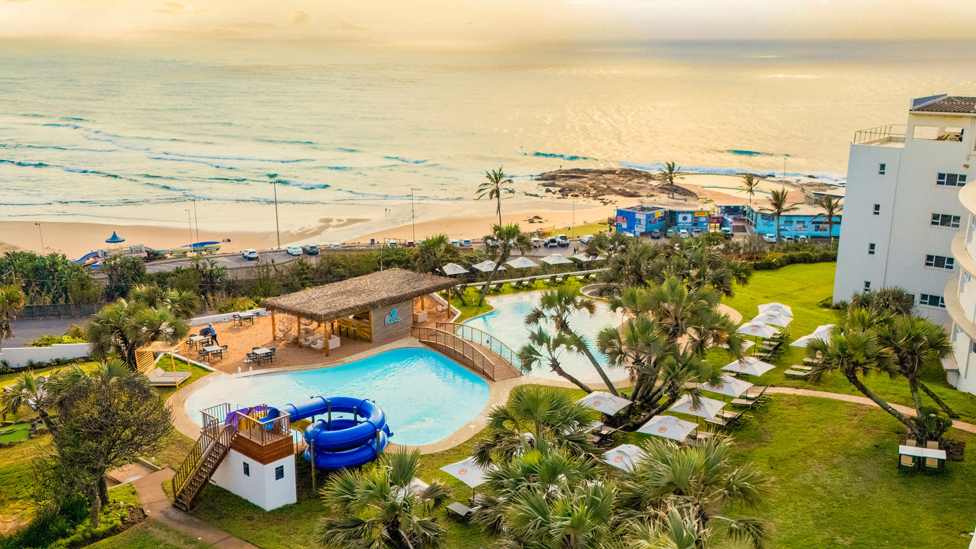 Pool with slide facing ocean